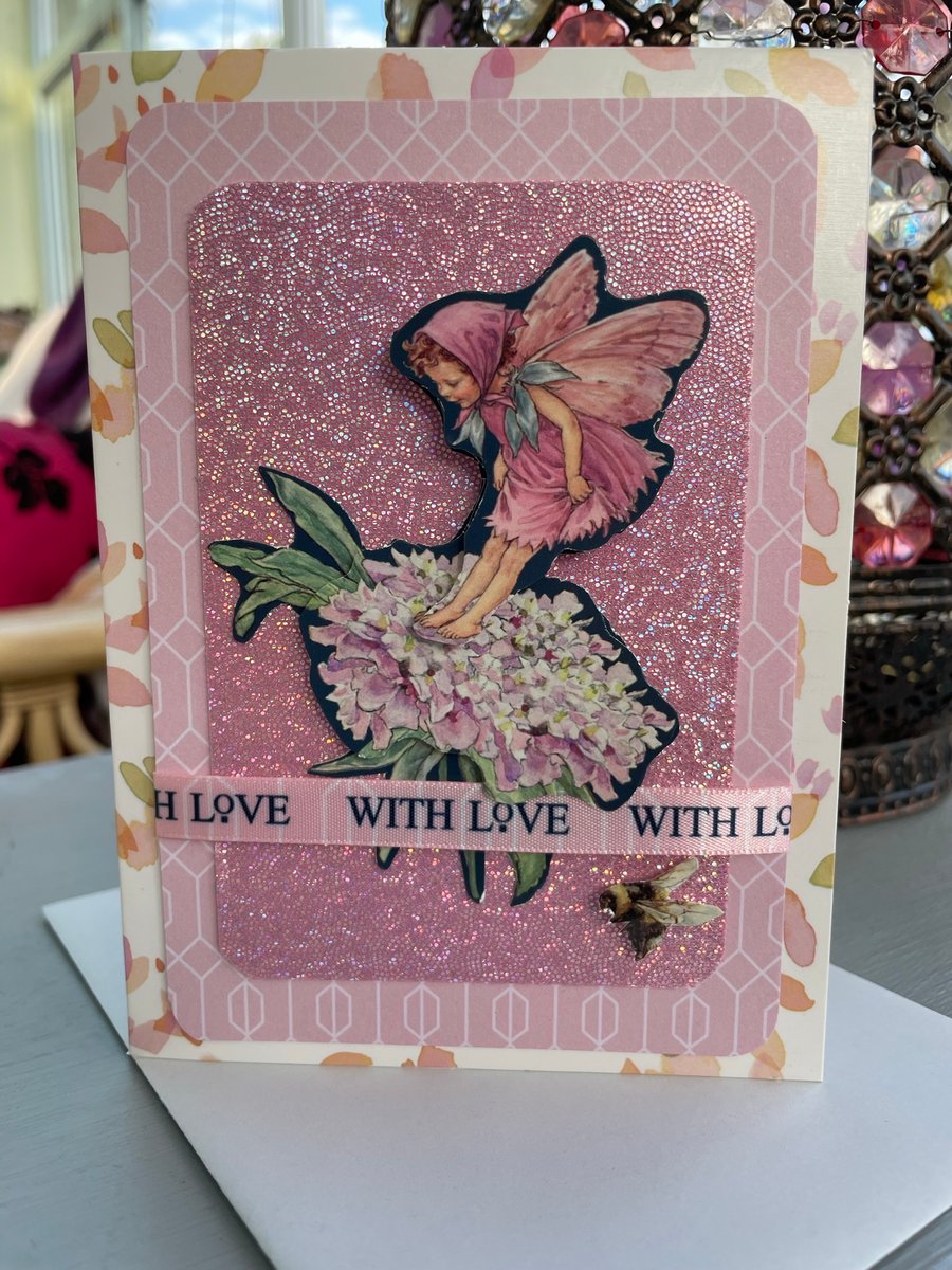 Flower Fairy fluttering on a flower with love Happy birthday card