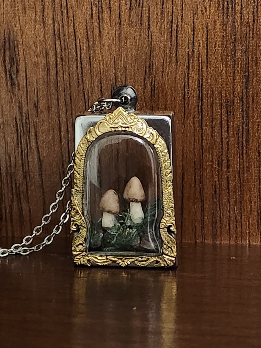 Tiny sculpted Polymer Clay mushrooms on tourmaline crystals in s steel frame