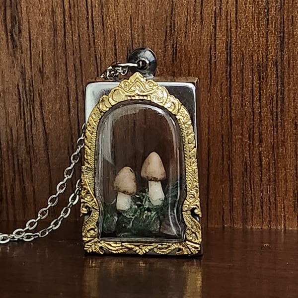 Tiny sculpted Polymer Clay mushrooms on tourmaline crystals in s steel frame