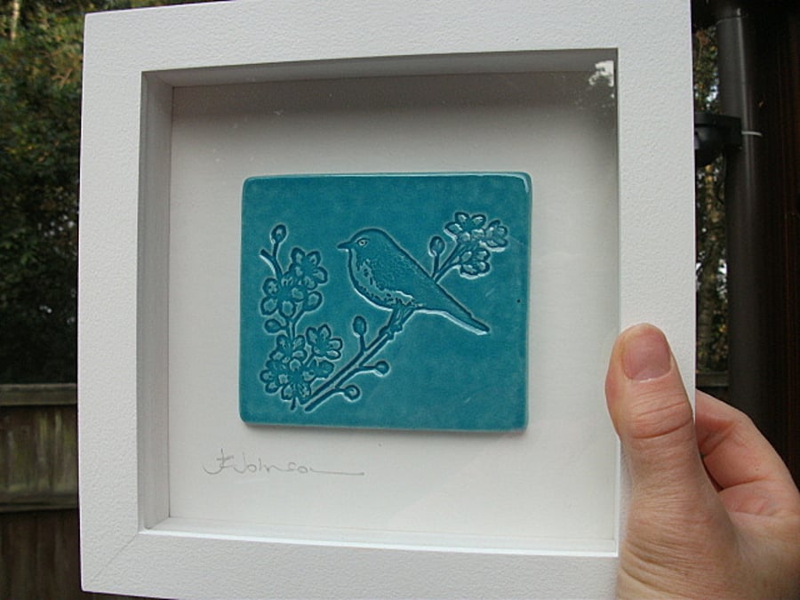 Turquoise ceramic plaque picture with a bird design - White wood frame