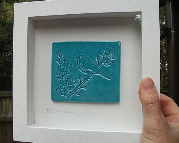 Turquoise ceramic plaque picture with a bird design - White wood frame