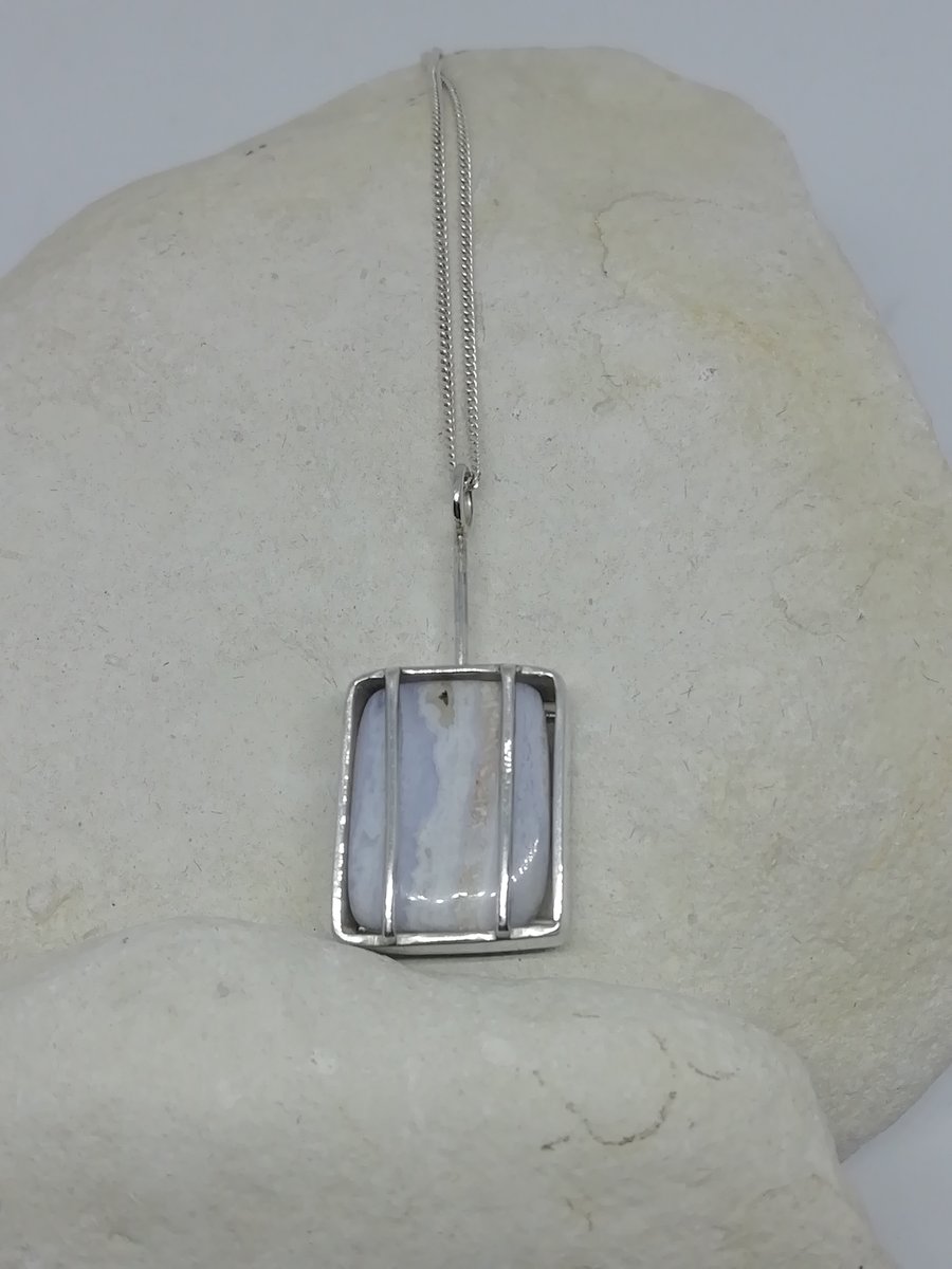 A Polished Blue Lace agate Set in a Cage Necklace