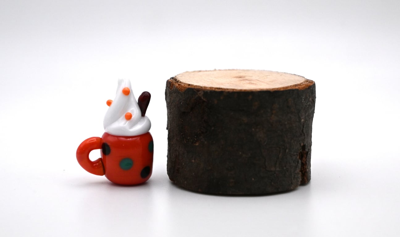 small glass hot drink with cream