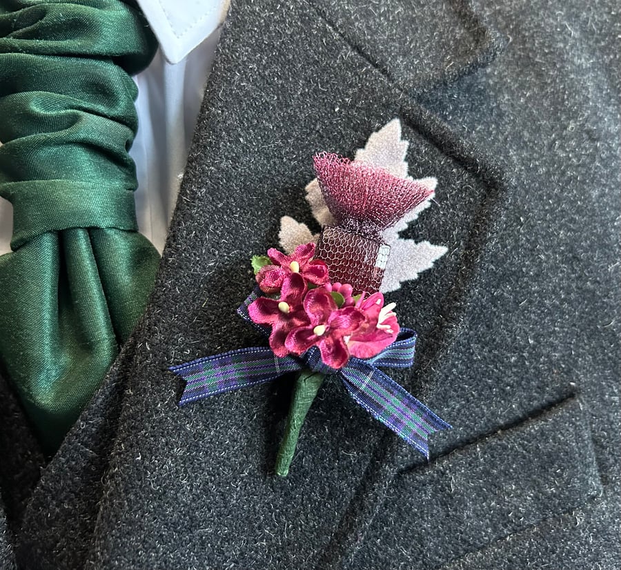 Handmade Buttonhole with a knitted wire thistle, burgundy flowers and tartan bow