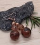 Conker brown and black dangly earrings with a bronze sheen - Image 3