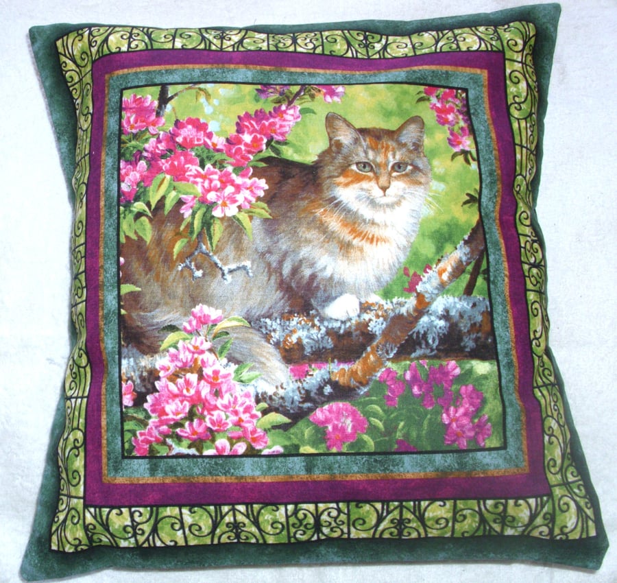 A pretty ginger, black and white kitten in a tree cushion