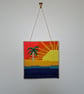 Wall art of a sunset island - adjustable hang length - Image 1