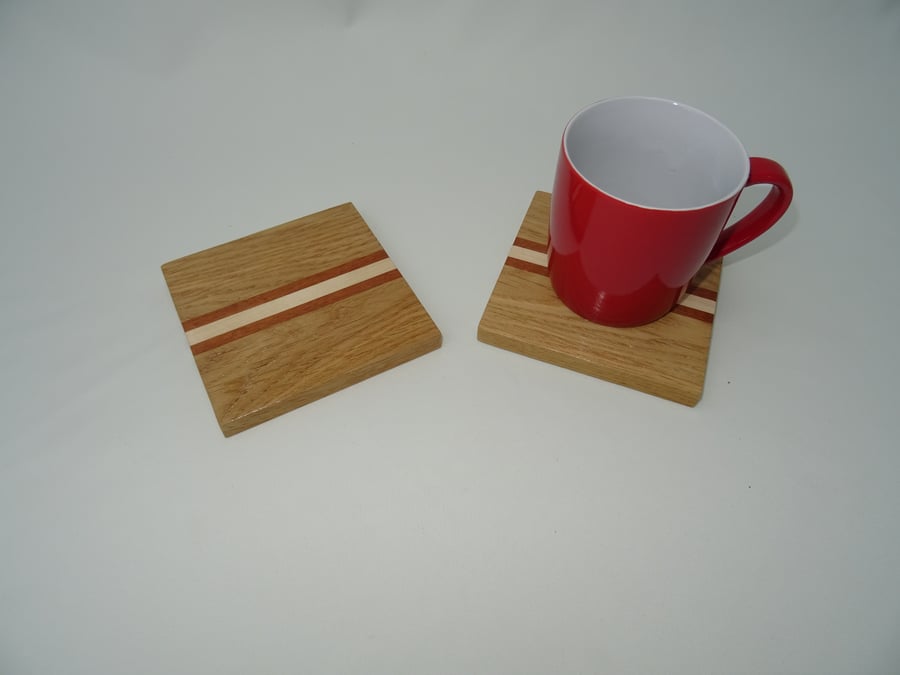 Pair of drinks coasters in Oak with Sycamore and Iroko stripes