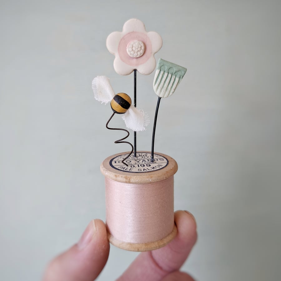 Clay Flowers and Bee on a Vintage Bobbin