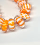Handmade orange and white patterned lamp work glass beads - Image 2