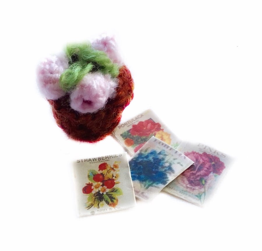 Knitted pink plant and seed packets