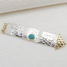 Handmade long sterling silver brooch, arrow shape with a Turquoise stone. 