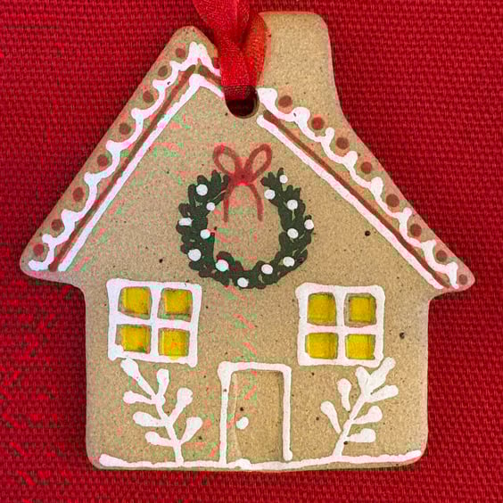 Gingerbread style hanging house decoration with hand painted design