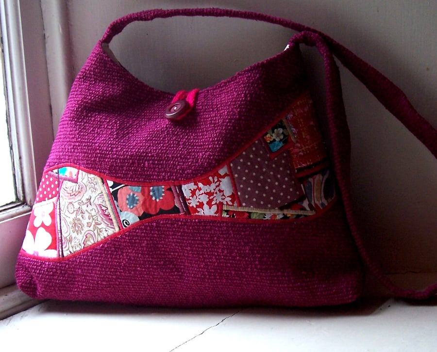 Soft textile handbag in magenta with feature panel of mixed patchwork