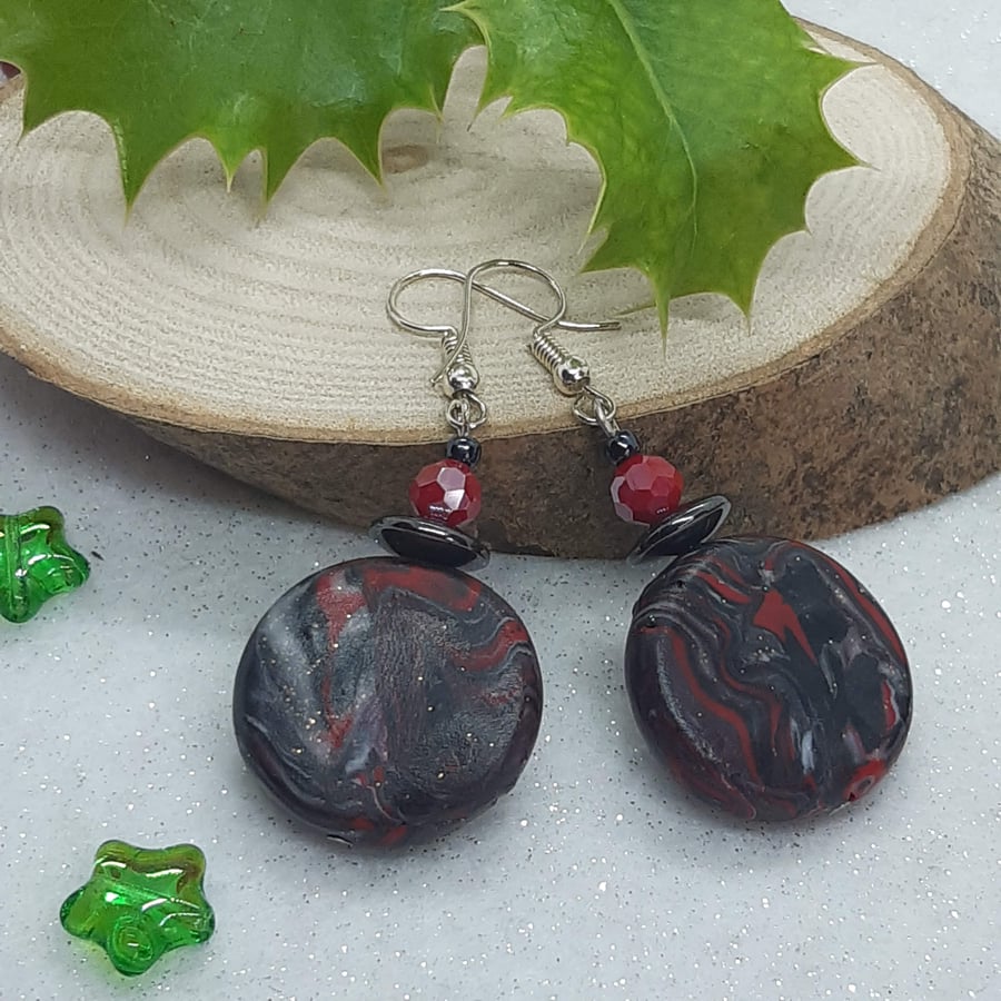 Red and black disc shaped earrings