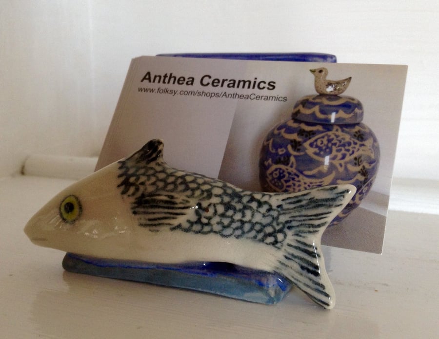 Business card holder with decorative sculpted fish