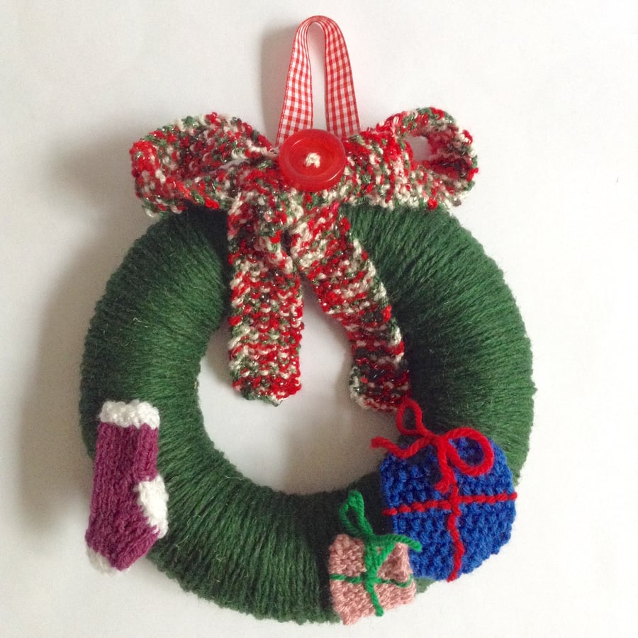 Green wool Christmas wreath with knitted decorations