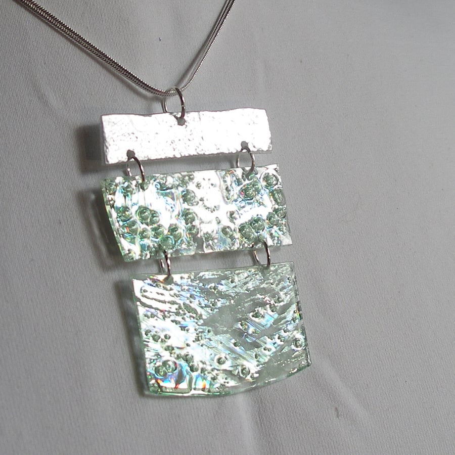 Three piece reflective pale green and silver pendant.
