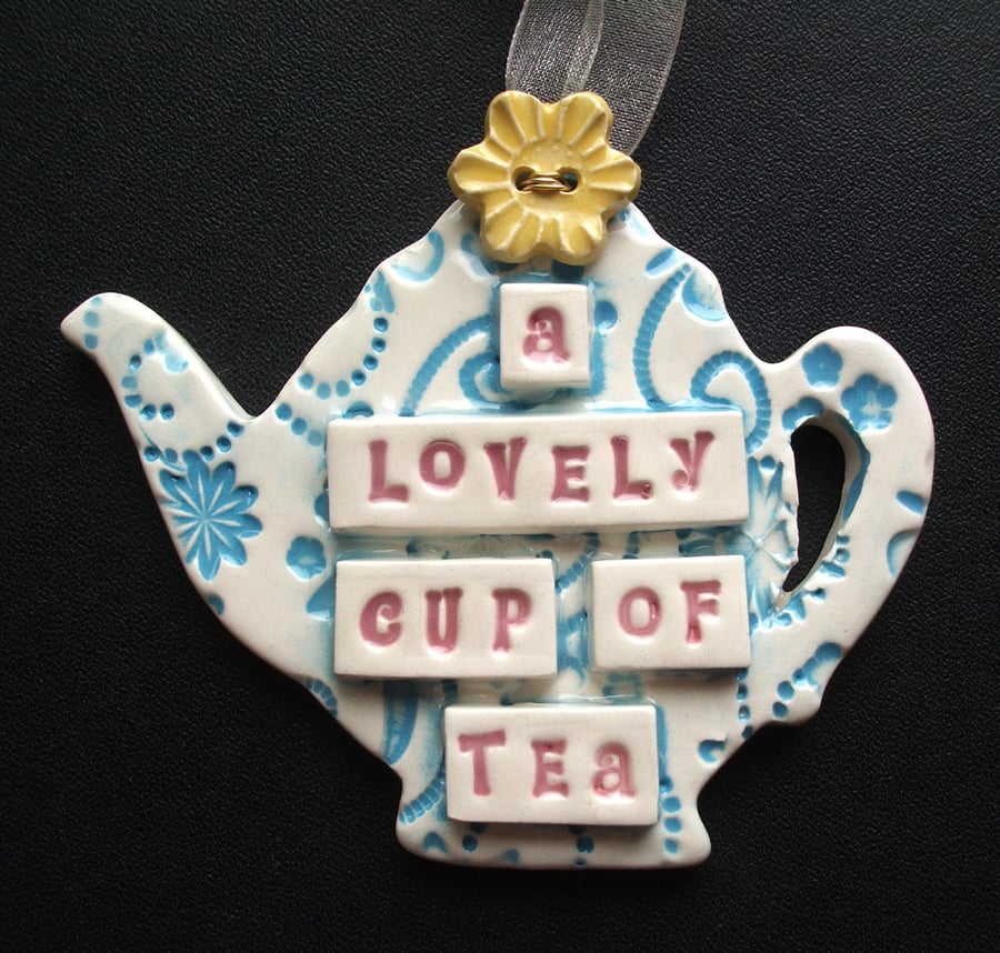 Ceramic teapot decoration with button flower