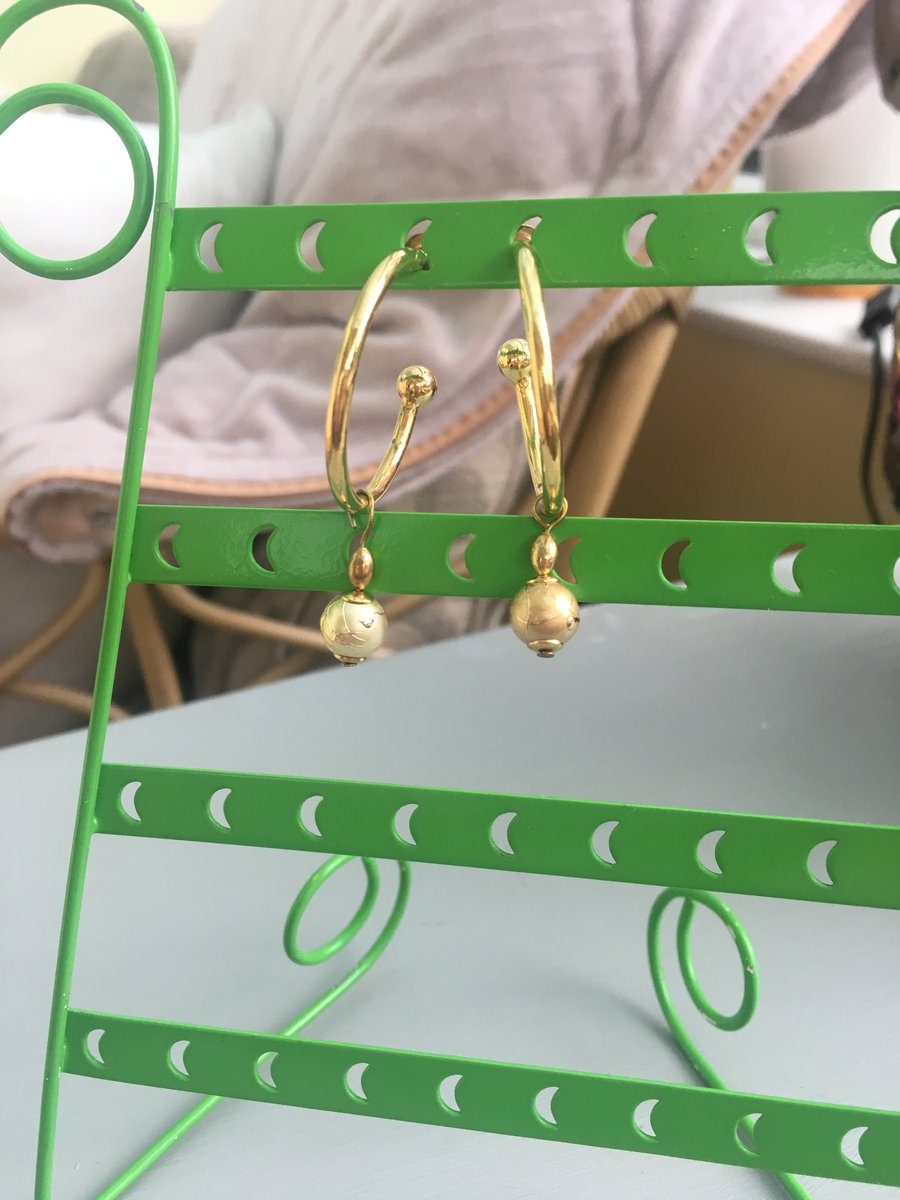 Gold tone hoop earrings with free moving gold bead