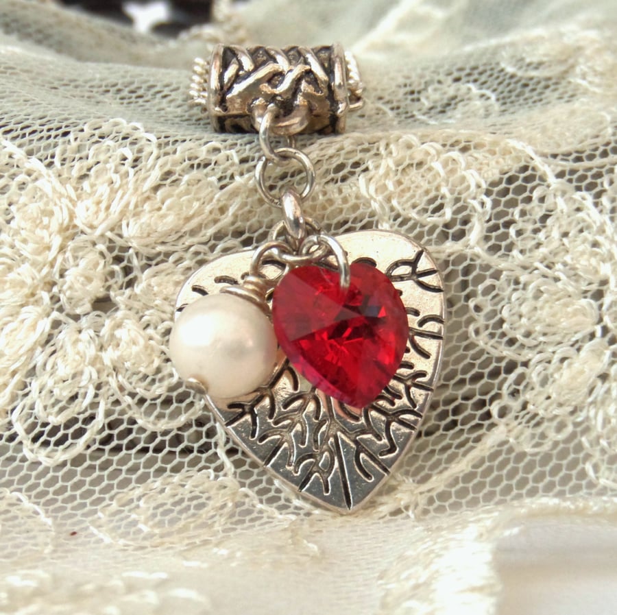 Tibetan silver charm necklace, with red Swarovski® heart crystal and pearl