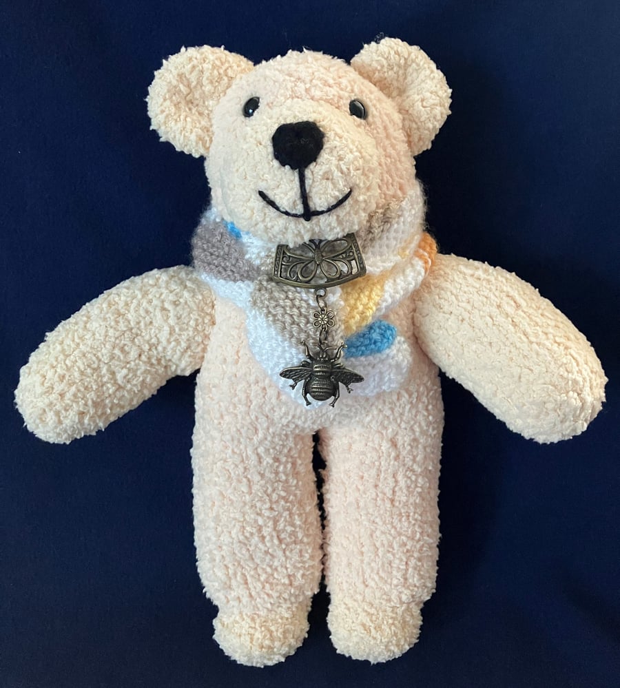 Cream Bear wearing a scarf and a Bee scarf bail