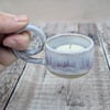 White and purple ceramic tealight holder with handle