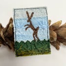 Upcycled boxing hare brooch pin or badge. 