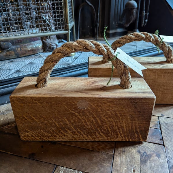 Solid oak and rope doorstop.