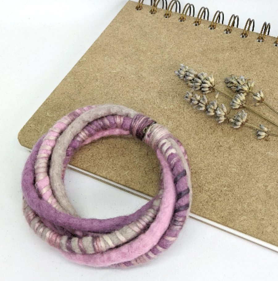 Felted cord bracelet in shades of pink