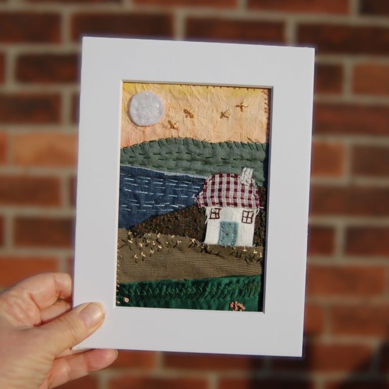Moon at sunrise.  Upcycled fabric hand stitched picture 