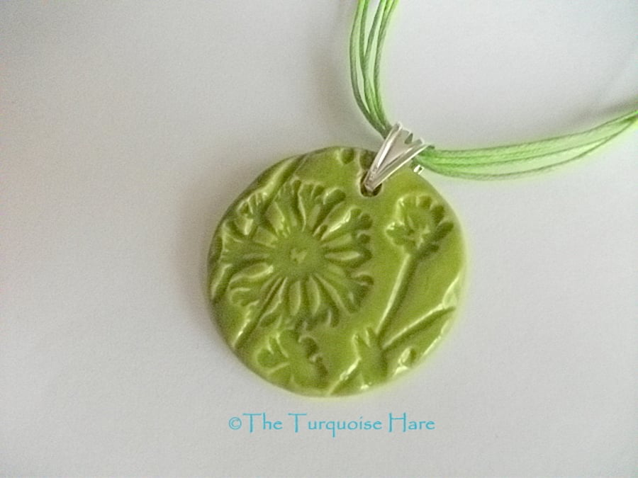 SALE - Green ceramic pendant necklace impressed with a floral design 