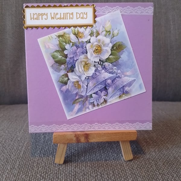 A small pink wedding day card with flowers