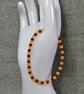 UV Reactive Orange Glass and Dark Metal Bead Elastic Bracelet - Image 6