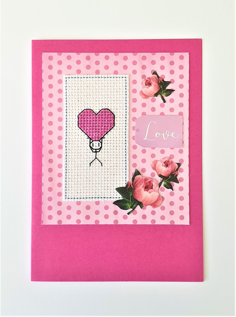 Stickman with a pink heart cross stitch card with Love wording and rose detail