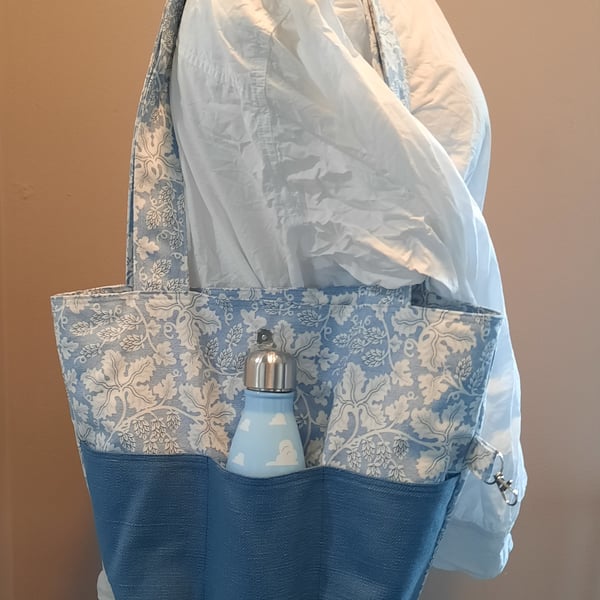 Blue tote bag with pockets and magnetic popper fastening.  