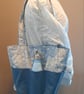 Blue tote bag with pockets and magnetic popper fastening.   - Image 1