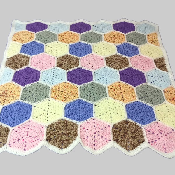 Crochet blanket with hexagon pattern and white border, multi coloured blanket
