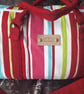 Striped holdall with shoulder strap.