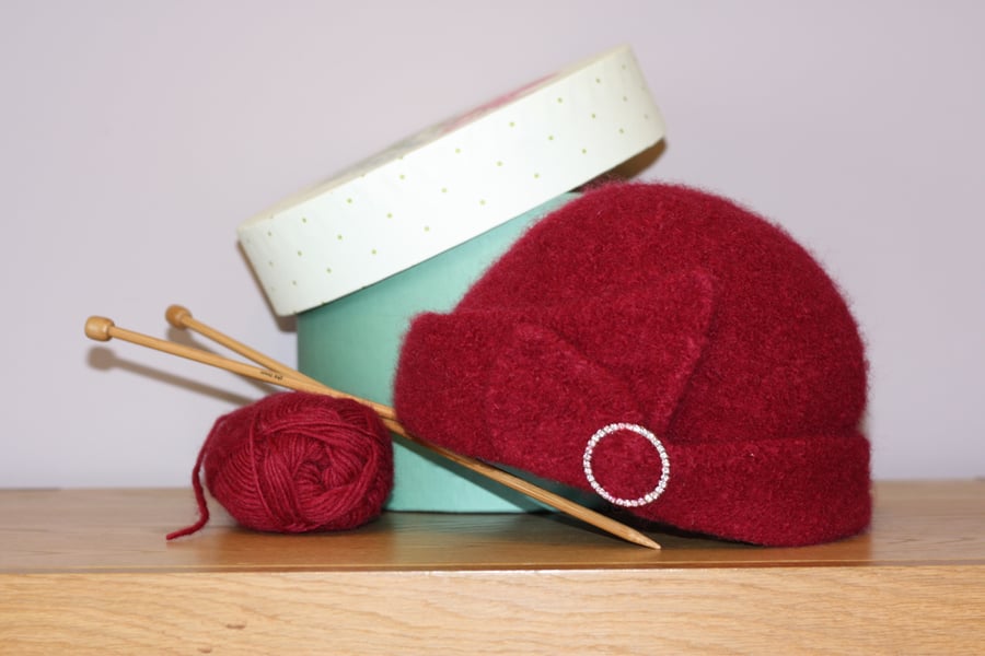 Modern cloche hat in berry red, hand-knitted and felted