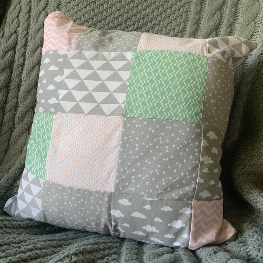 Grey, pink and green patterned patchwork cushion