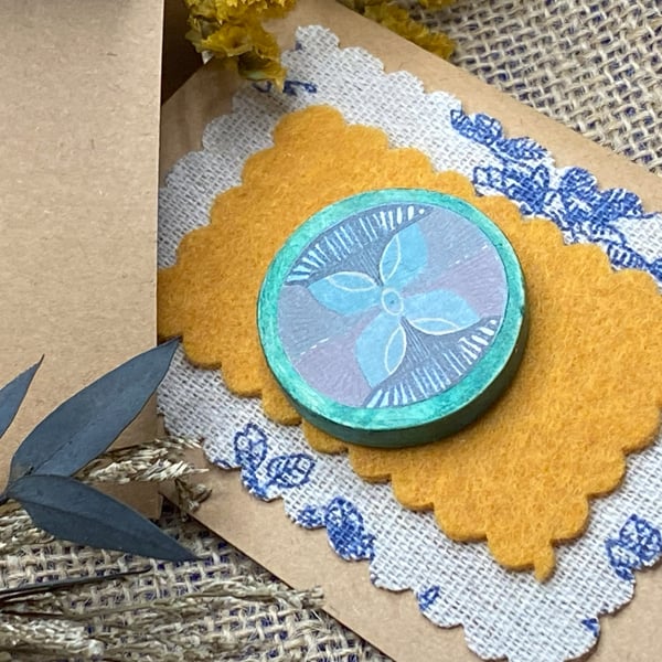 Handmade wooden brooch with floral motif 