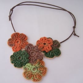 Crochet flower necklace in brown, orange and green