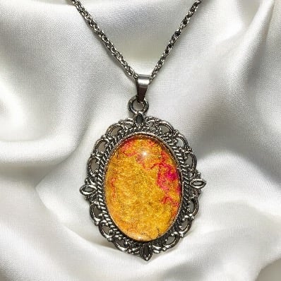 Vintage style pendant necklace using handmade felt under glass cabochon, orange