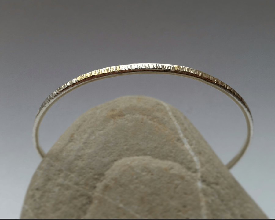 Simple textured slim silver bangle with gold accent