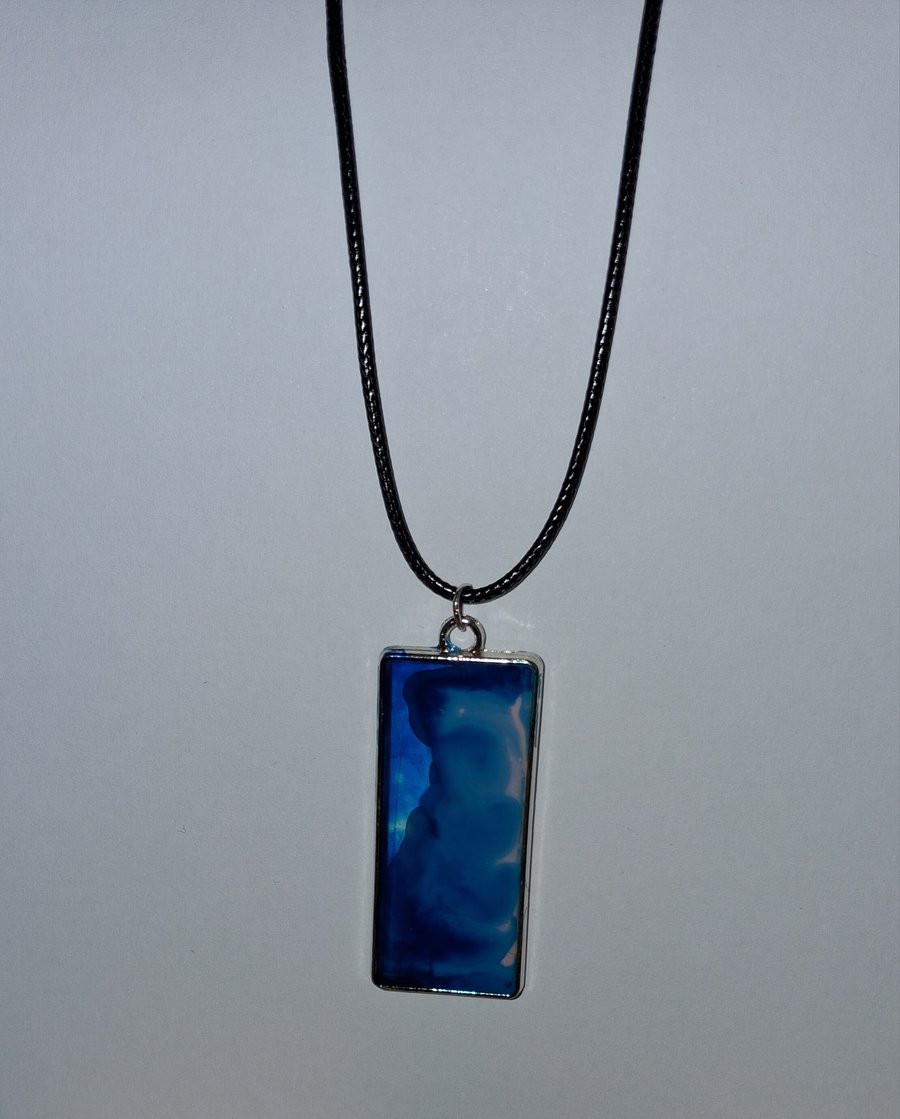 Handmade resin blue and pink rectangular pendant on  black waxed cord