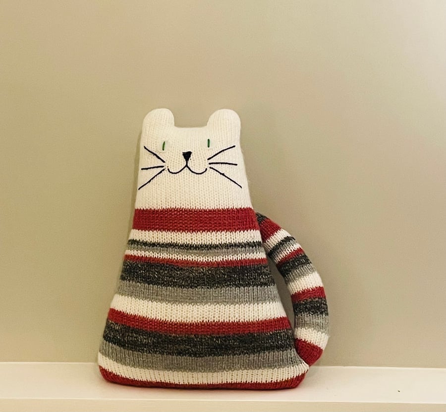 White cat with red and grey stripes