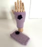 Hand knitted wrist warmers in pale purple wool with darker purple flowers