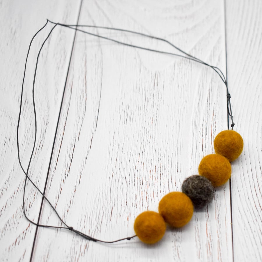 Felted bead necklace in ochre yellow and brown wool