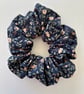 Cotton scrunchie hair accessory in navy with delicate floral print - Image 1
